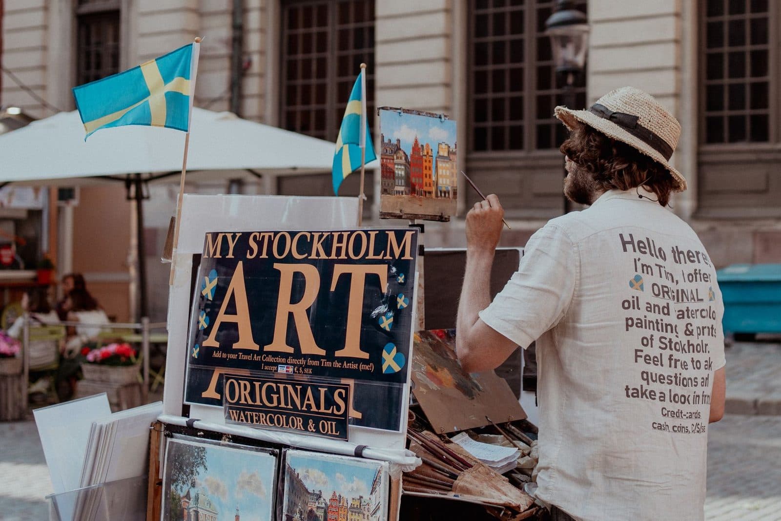 A street artist in Stockholm painting cityscapes with watercolor and oil.