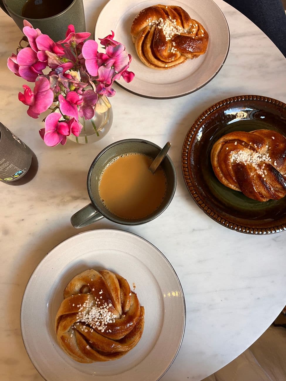 Delightful Swedish pastries and coffee on a marble table, perfect for a cozy coffee break.