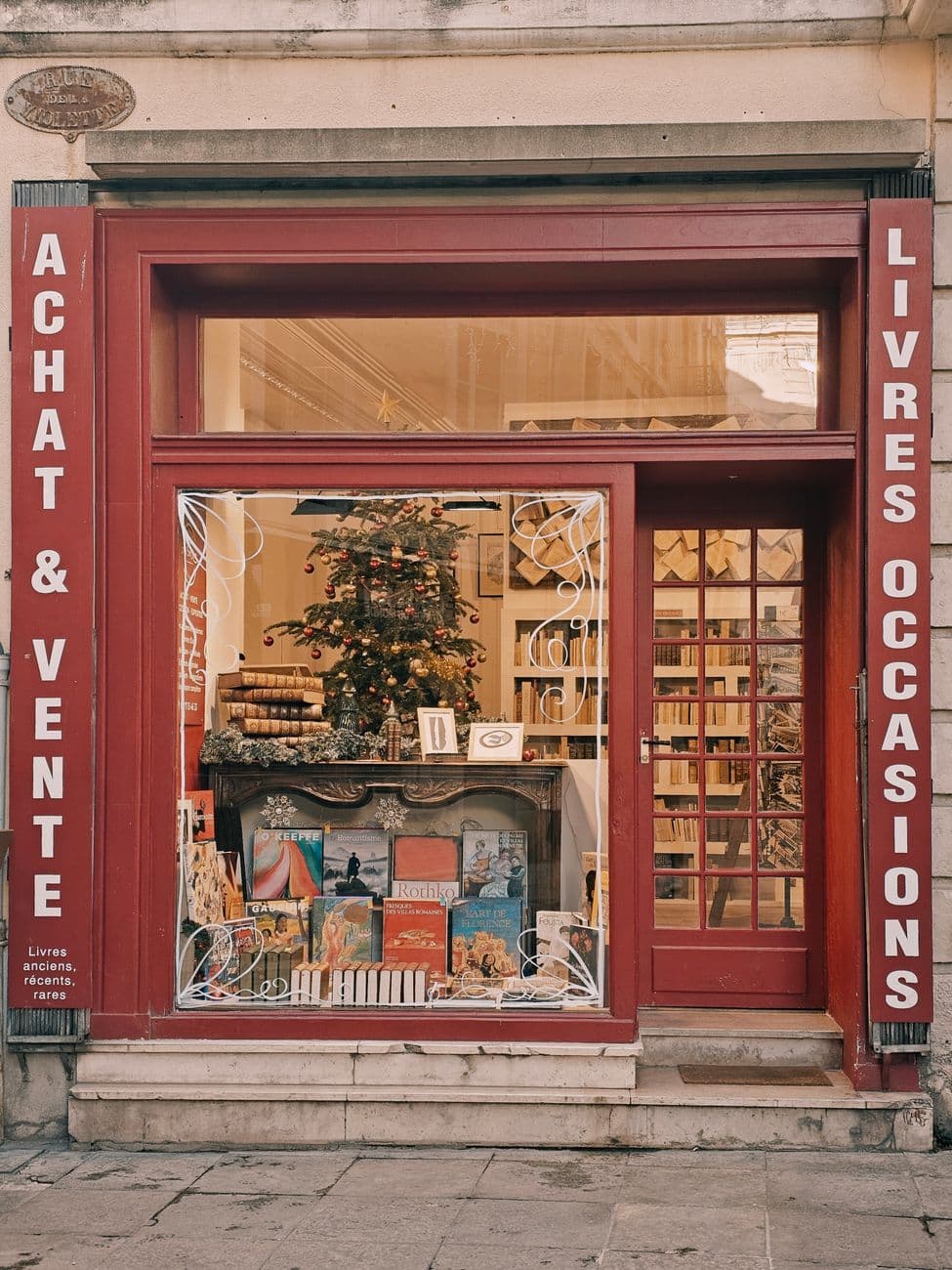 Discover a quaint vintage bookstore with a classic facade in France.