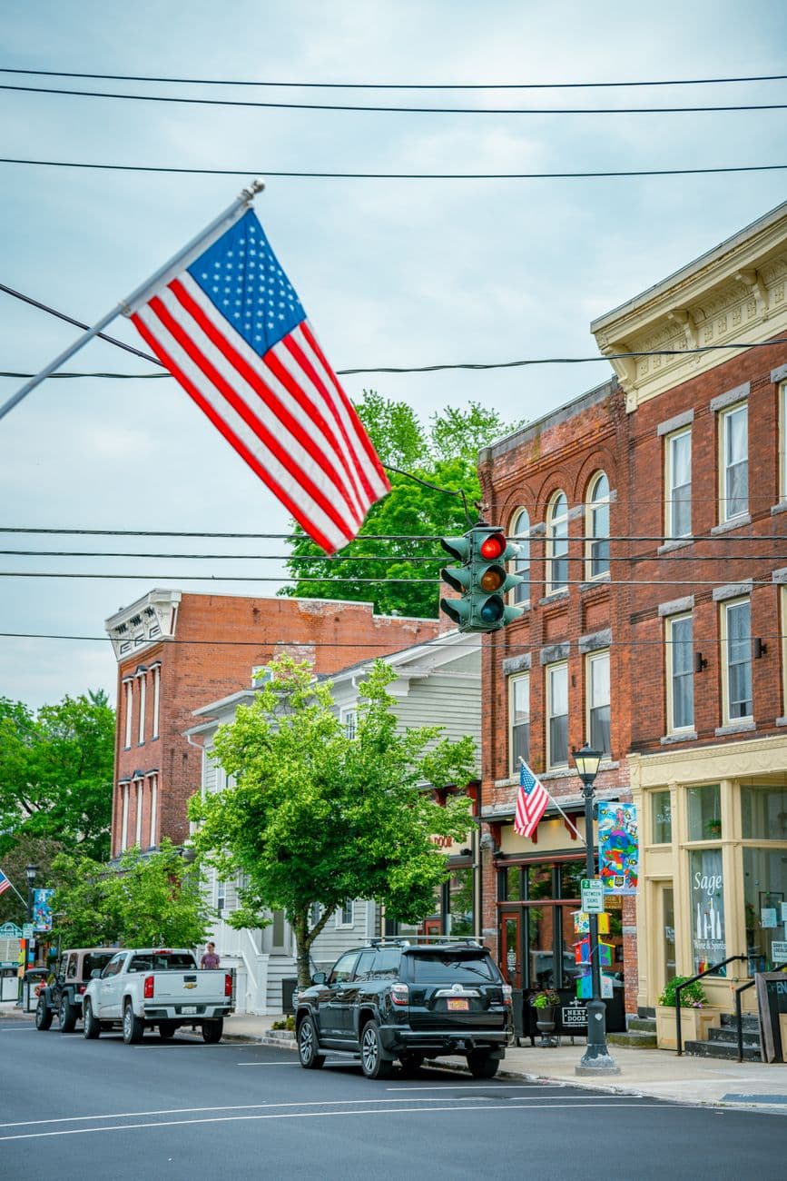 Charming small-town street scene in America with flags and classic architecture.