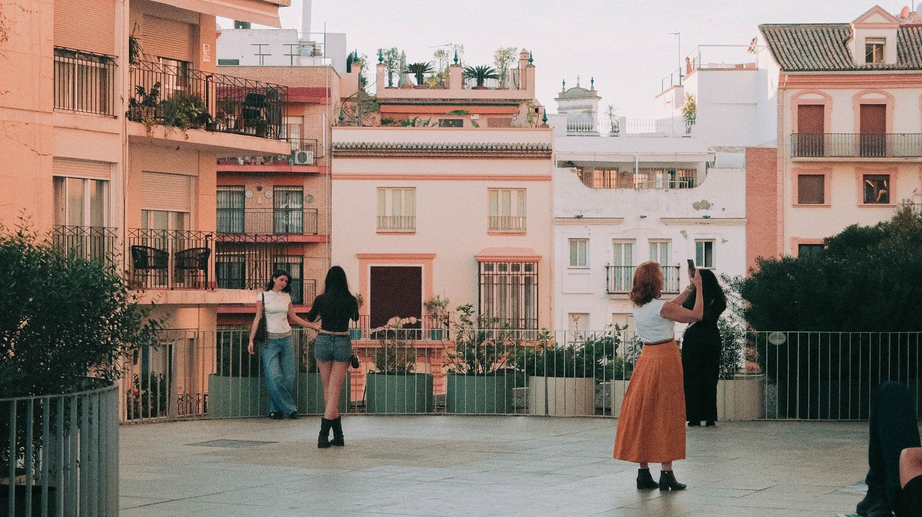 A group enjoying an evening on a rooftop terrace in Seville, highlighting urban life and architecture.