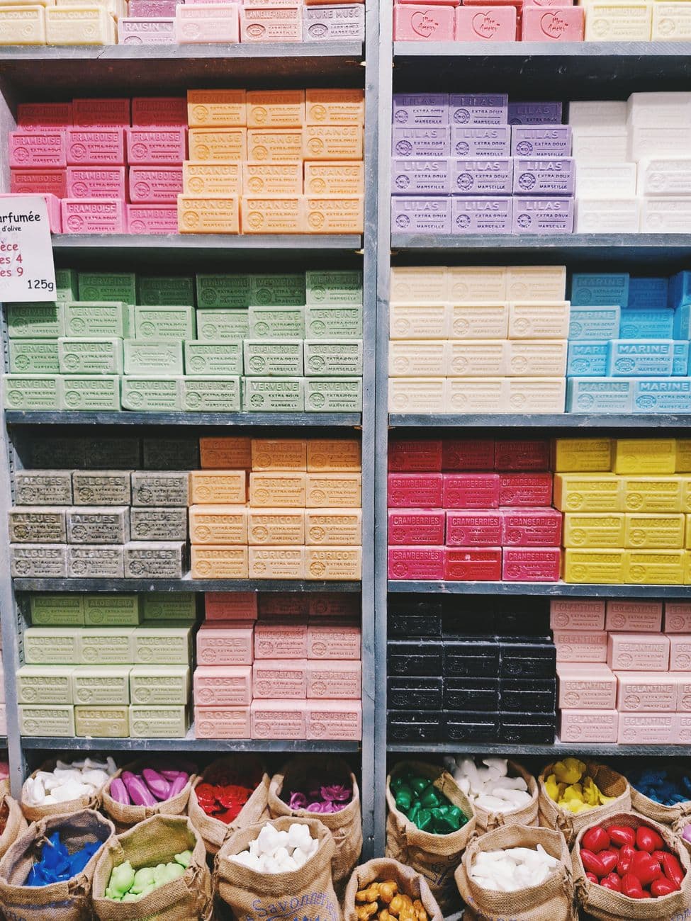 Vibrant handmade soap bars neatly stacked in a market in Antibes, France.