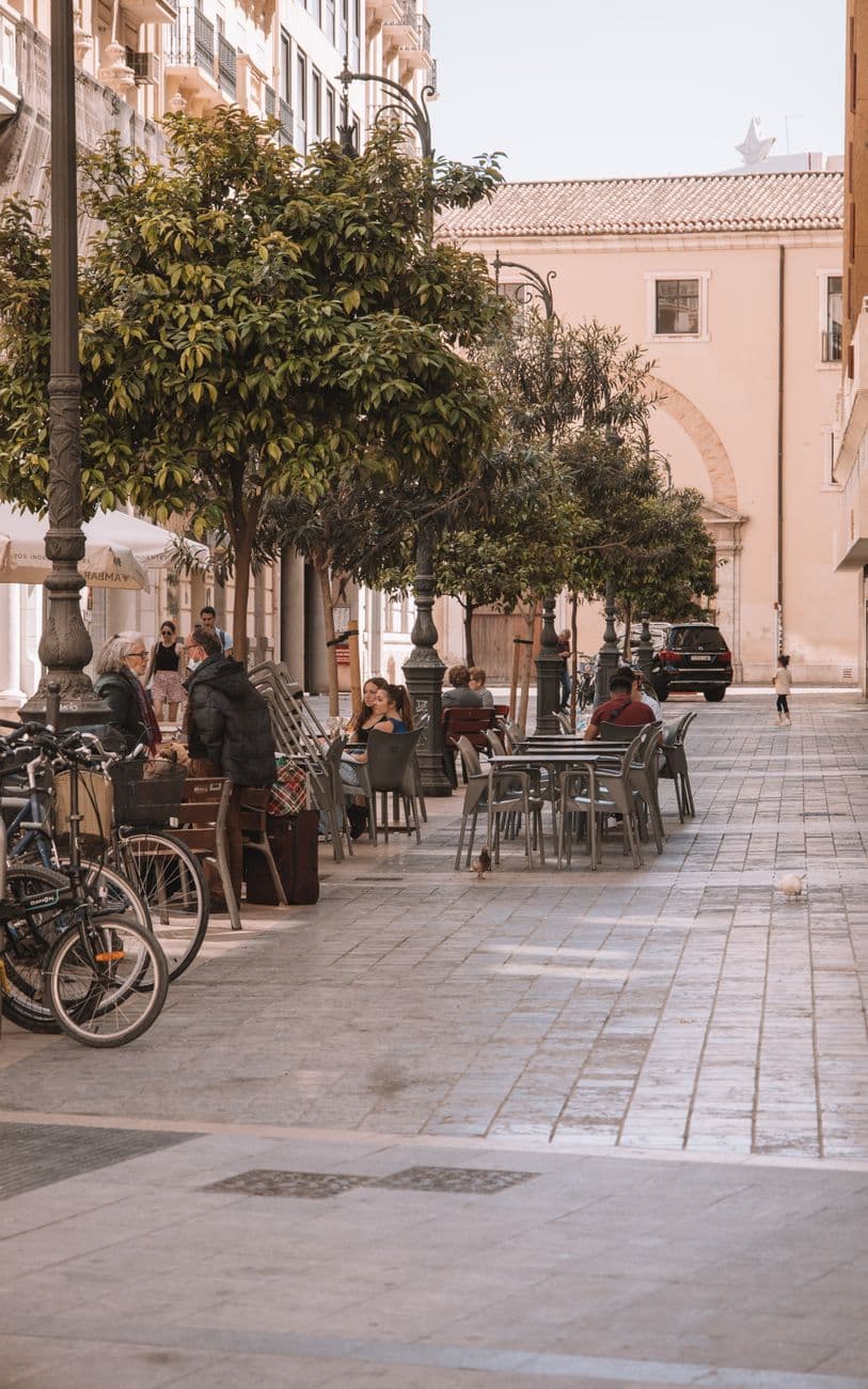 Street view of outdoor cafes and dining in scenic Valencia, Spain.